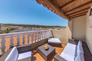 a balcony with chairs and a view of a city at Casa do céu in Silves
