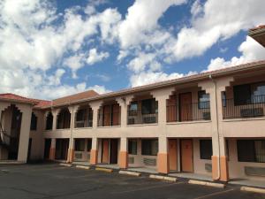 a large white building with a lot of windows at Luxury Inn in Albuquerque