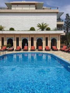 a swimming pool in front of a building at Отель Оазис в Чакви in Chakvi