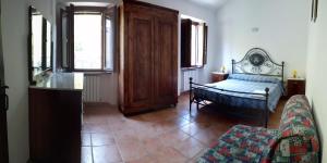 a living room with a bed and a couch at Agriturismo Gli Ippocastani in Pergola