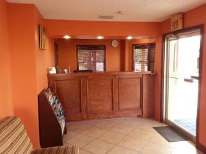 a living room with orange walls and a large window at Texas Inn in Brownsville