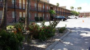 a parking lot in front of a building at Texas Inn in Brownsville