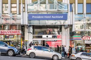 a group of cars parked in front of a building at President Hotel Auckland in Auckland