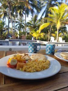 a plate of food on a table at Blue Mango Beach Hotel in Guachaca