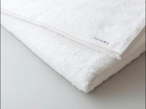 a white bedsheet with the word mattress on it at 9h nine hours Nakasukawabata Station in Fukuoka