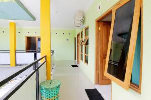 a hallway of a house with a staircase at Losmen Alden in Yogyakarta