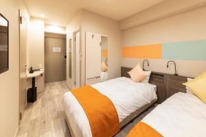 En eller flere senge i et værelse på SARASA HOTEL Dotonbori