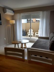 a living room with a couch and a table at Habitania Bahia - Cochera opcional in Bahía Blanca