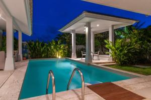 a swimming pool in a villa at night at Samui Sunset 22G in Choeng Mon Beach