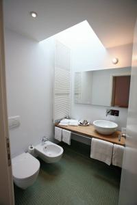 a bathroom with two sinks and a mirror at Hotel La Sosta in Cisano Bergamasco