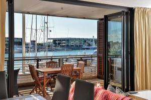 a balcony with a table and chairs and a marina at QV Stylish Waterfront Apartment - 317 in Auckland