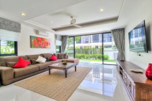 a living room with a couch and a table at 4BDR Pool Villa In Laguna Park #40 in Bang Tao Beach