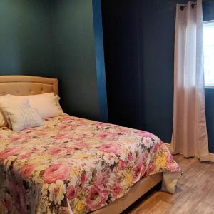 um quarto com uma cama com colcha floral em Baby Blue Sky - Price 2bd - Newly remodeled - nearby trails em Price