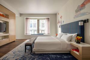 a bedroom with a large bed and a television at Hyatt Centric Wall Street New York in New York +37 photos