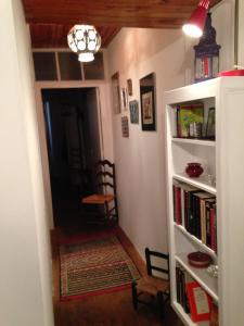 a hallway with a book shelf filled with books at Maison de village in Ortiporio