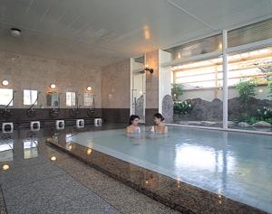 two women are standing in a swimming pool at Hotel Yuzawa Yuzawa Denkiya in Yuzawa