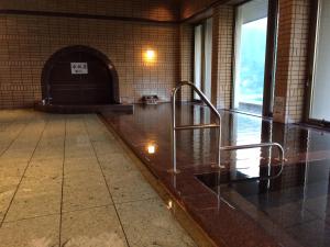 an empty room with a stairway in a building at KKR Yuzawa Yukiguni in Yuzawa