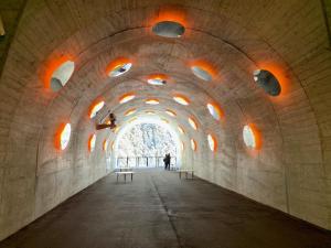 a tunnel with benches in a building with a window at KKR Yuzawa Yukiguni in Yuzawa