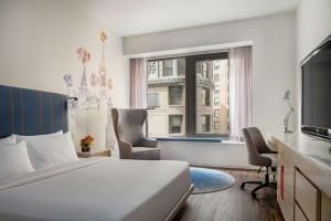 a hotel room with a bed and a window at Hyatt Centric Wall Street New York in New York