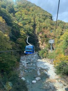 a blue car on a ski lift in a mountain at KKR Yuzawa Yukiguni in Yuzawa