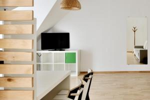 TV a/nebo společenská místnost v ubytování Draugų namai