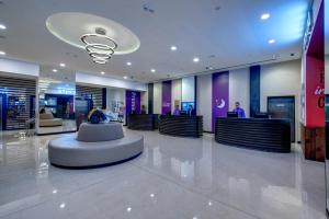 a lobby with a waiting area in a building at Premier Inn Dubai Ibn Battuta Mall in Dubai