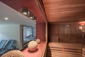 eine Sauna mit zwei Stühlen und einer Bank in einem Raum in der Unterkunft Hotel Bergwelt in Längenfeld + 135 Fotos
