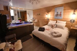 a bedroom with a bed with two dogs laying on it at Le Skidoux in LʼHuez