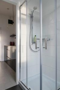 a shower with a glass door in a bathroom at Modern studio in the heart of the city in Maribor