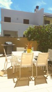 a white table and chairs on a patio at Villa A DUE PASSI DAL MARE in Taranto