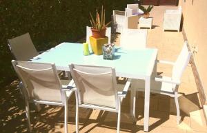 a blue table and chairs with plants on a patio at Villa A DUE PASSI DAL MARE in Taranto
