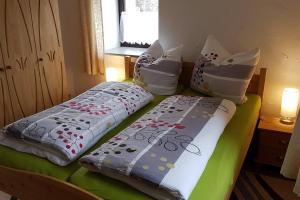 two beds sitting next to each other in a bedroom at Waldhufenidyll Königswalde im Erzgebirge in Königswalde