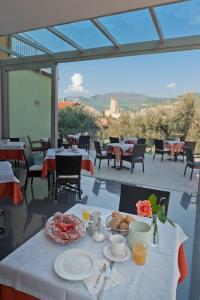 a table with plates of food on top of a patio at Hotel Augusta in Malcesine