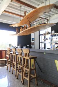 a bar with a row of wooden stools at 巨缿民宿巨象民宿 in Sanyi