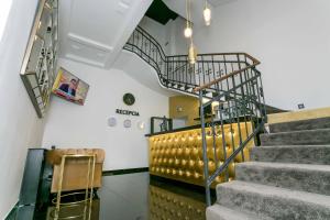 a staircase in a building with a metal railing at Apart Hotel GOLDEN apartments in Košice