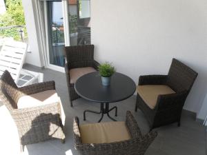 a patio with a table and chairs on a balcony at Apartments Stella in Krk