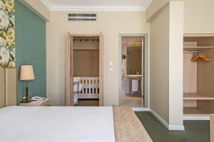 A bed or beds in a room at Airotel Stratos Vassilikos Hotel