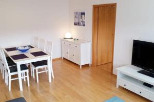 a living room with a dining room table and a television at Altstadtflair in Stolberg