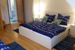 a bedroom with a bed with blue sheets and pillows at Altstadtflair in Stolberg