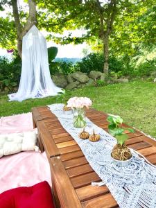 a picnic table with a white table cloth and flowers at Jing Lai Hui Lan Homestay in Ruisui