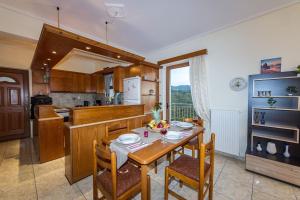 a kitchen with a table and some chairs and a table and a kitchen at Breathtaking Sea View, Close To The Beach in Kalamata
