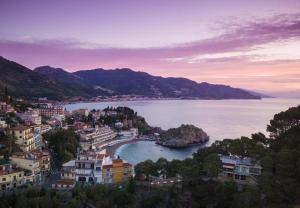 a view of a city and a body of water at Taormina Panoramic Hotel in Taormina