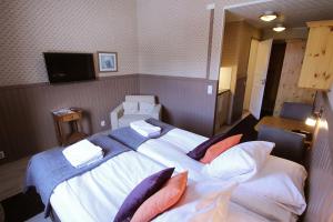 Postel nebo postele na pokoji v ubytování Hotel Hullu Poro