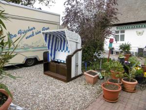 un jardín con TV, un remolque y plantas en Ruegen_Fewo 58_1, en Neuendorf