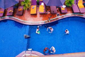 a group of people swimming in a swimming pool at Okay Guesthouse Siem Reap in Siem Reap