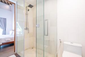 a glass shower in a bathroom with a toilet at Luxury Villa Dore in Jimbaran
