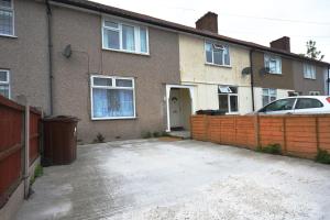 a house with a car parked in front of it at London Deluxe Four Bedroom House in Dagenham