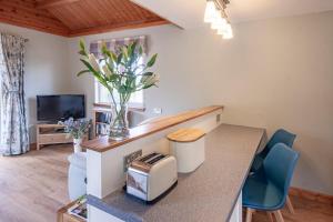 a kitchen and living room with a table and chairs at Osprey lodge in Elgin