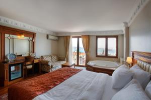 a hotel room with a large bed and a bathroom at Hotel Sumengen in Istanbul