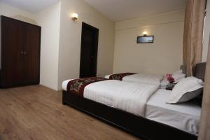 Postelja oz. postelje v sobi nastanitve Hotel Hema
